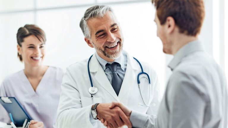 a doctor happily handshake with their patient