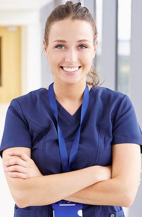 A female nurse smiling in blue dress